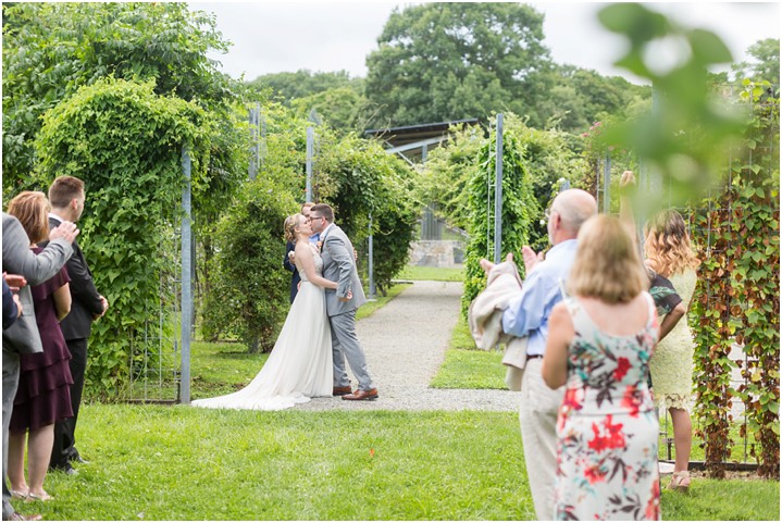 bride and groom first kiss garden wedding ceremony