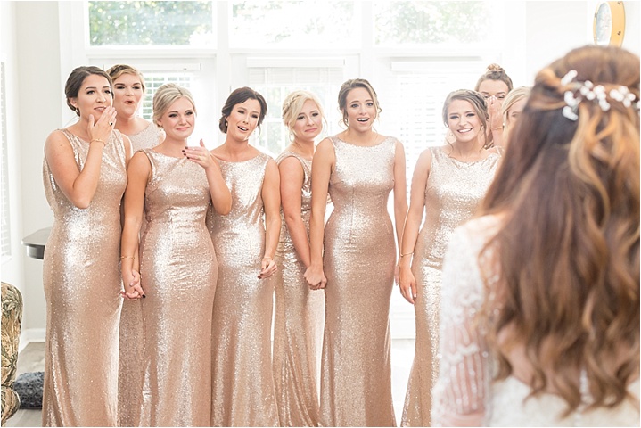 brides first look with bridesmaids in gold dresses Greenville wedding