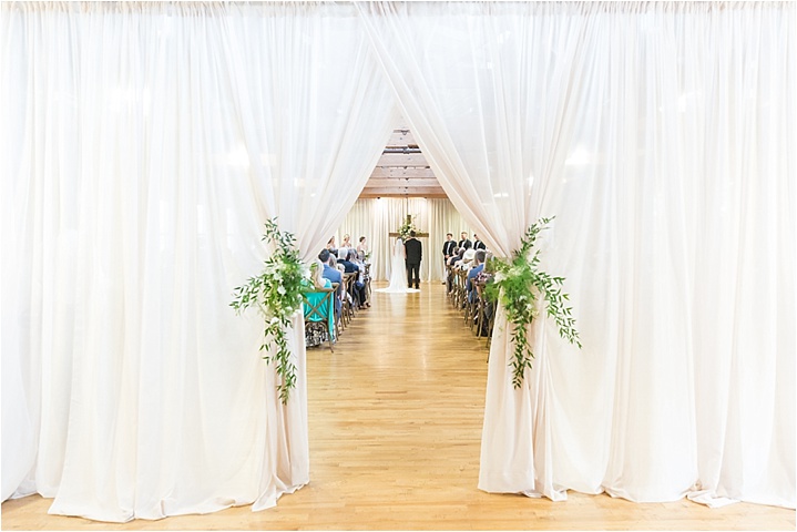 white and greenery ceremony decor with ryan and alyssa photography
