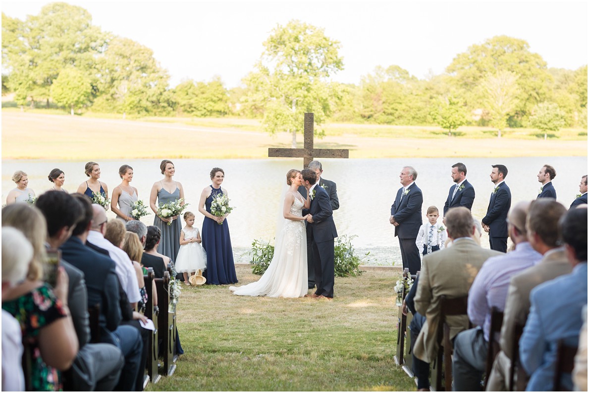 bride and groom first kiss outdoor southern wedding