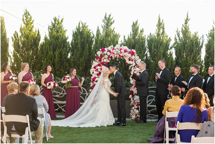 first kiss bride and groom rooftop garden wedding