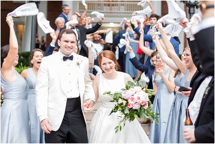 joyful bride and groom reception exit