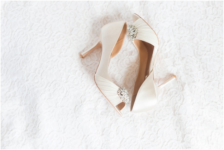 Wedding shoes laid out on wedding dress