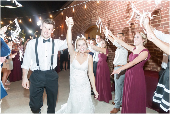 bride and groom under sparkler exit