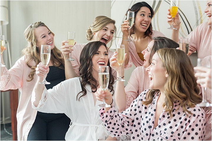 bride and bridesmaids toasting champagne Greenville wedding